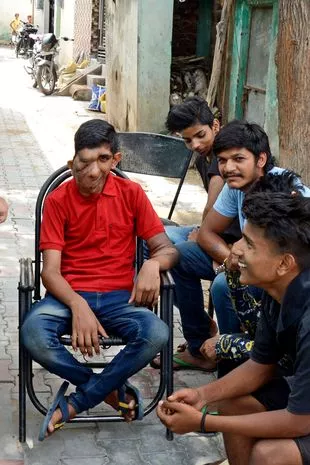 Bhupinder Singh with his friends in the street